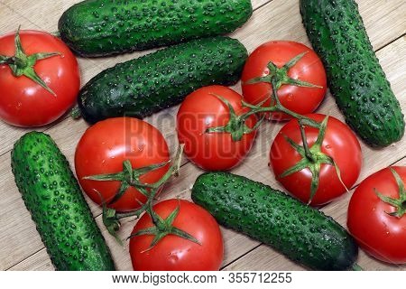 Tomatoes And Cucumbers On A Wooden Table. Healthy, Vegetarian Food. Natural Food.vegetables On A Tab