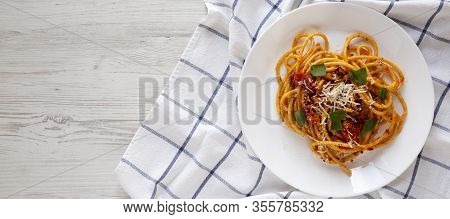 Homemade Bucatini All Amatriciana Pasta In A Plate On A White Wooden Surface, Top View. Flat Lay, Ov