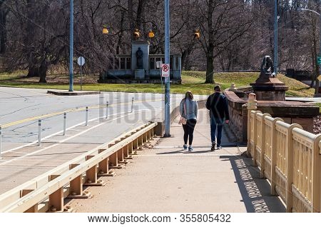 Pittsburgh, Pennsylvania, Usa 3/15/20 A Couple Walking On The Panther Hollow Bridge In Schenley Park