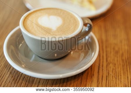 Coffee Cup Fresh Cream Organic Cappuccino On Table In Cafe. Latte Macchiato Drink In Glass Close Up.