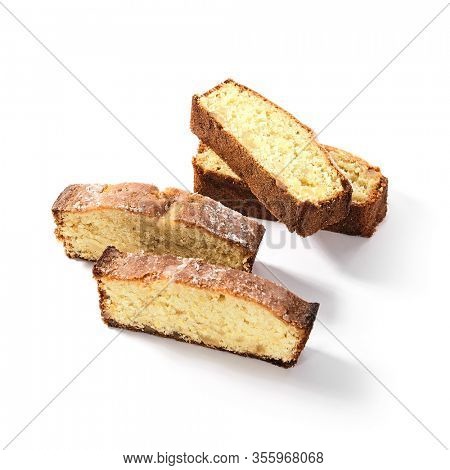 Four pieces of classic sponge cake, biscuit or biscotto isolated on white background. Soft yellow homemade kasutera slices or lemon vanilla loaf pound cakes closeup