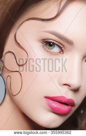 Beauty portrait, hair styling. Close-up of a beautiful young woman with fresh shining make-up and refined elegant hairstyle.