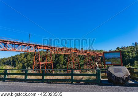 New Zealand - April 9 2022; Red Structure Of Makatote Viaduct, Bridge Number 179, Against New Zealan
