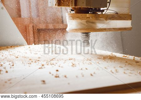 Cnc Machine At Carpentry Workshop. Cutting Wood With Various Router Bits.
