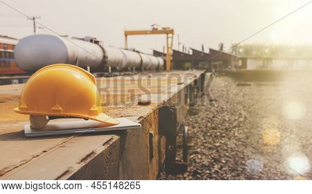 Engineer's Helmet, Railway Technician Working In A Train Garage Station, Places Laptop Computer On A