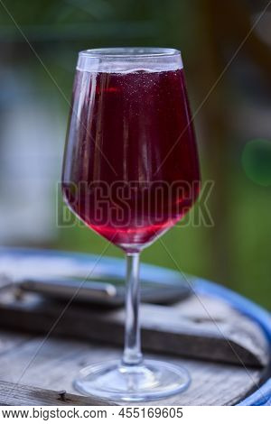 A Glass Of Red Wine And Mineral Water, Also Called Sprit.