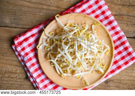 Bean Sprouts On Wooden Plate Table Background In The Kitchen, Raw White Organic Bean Sprouts Or Mung