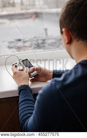 Man Using Finger Pulse Oximeter, Healthcare Monitoring Concept. Pulse Oximeter On A White Background
