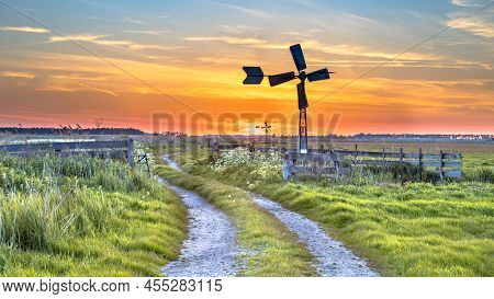 Old American Windmill At Sunset In Dutch Rural Landscape Near Jisp, Noord Holland, Netherlands