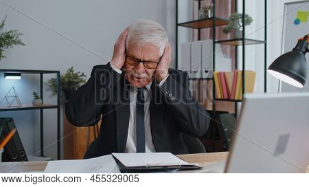 Senior Mature Older Business Man Accountant, Analysing Paperwork Documents Loses Becoming Surprised 