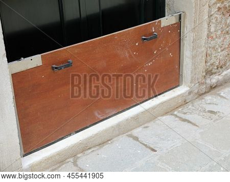 Sturdy Practical Bulkhead In Wood And Steel To Protect The Entrance To The House During High Tide On