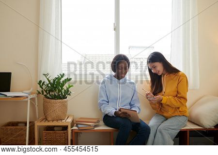 Teenge Girls Making Cheat Sheets For Exam, They Are Writing Dates And Formulars On Sticky Notes