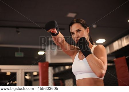 Young Fitness Woman With Hands In Black Bandages Posing In Fighting Stance.
