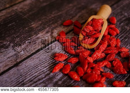 Dried Chinese Wolfberries Or Goji Berry Chinese Herb Or Matrimony Vine In The Woodden Scoop Near Woo