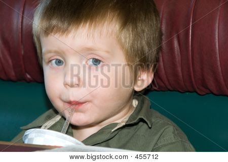 Boy Sipping Through A Straw