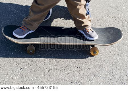 A Caring And Loving Father Teaches His Three-year-old Son To Skateboard.