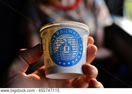 India - January, 2017: Man's Hand Holding Paper Cup With Indian Railway Inscription And Image Of A B