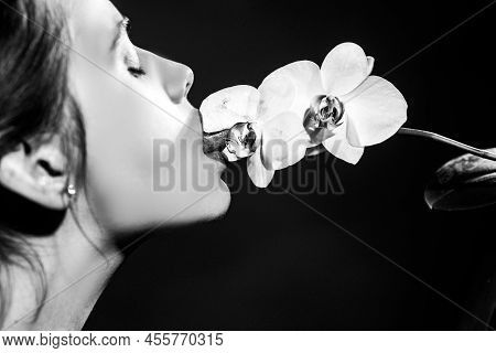 Sexy Girl Lick Orchid Flower. Orchids Oral Tongue. Sensual Young Woman Suck Floral Orchidea. Red Lir