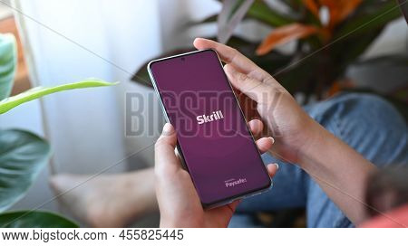Chiang Mai, Thailand. Jan 30, 2022.woman Holding Smart Phone With Skrill Application On Screen. Skri