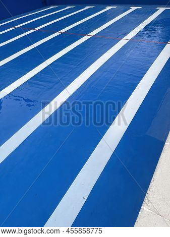 Lines Of The Bottom Of A Half Filled Blue Pool With A Composition With The Lines Of The Roads Vanish