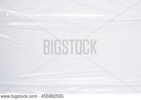 Transparent Plastic Wrap On White Color Background. Crumpled Wrinkled Plastic Cellophane. Reflecting
