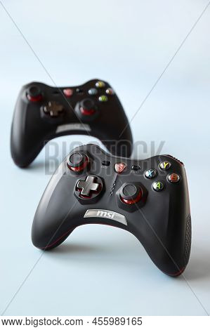 Two Msi Joystick Gaming Controller On Light Blue Background.