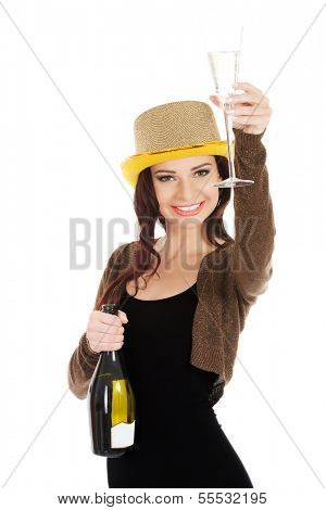 Beautiful woman in party dress, golden hat, brown bolero jacket is making a toast with champagne. Isolated on white.