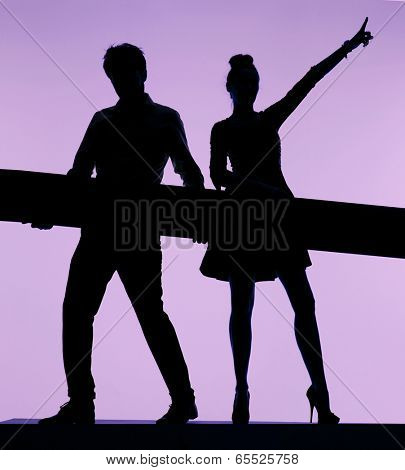 Young couple silhouette holding board