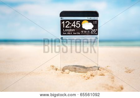 Futuristic Smart phone (copy space display) with a transparent display in the sand on the beach. Concept actual future innovative ideas and best technologies humanity.