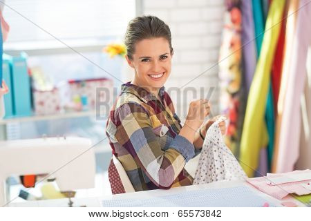 Happy Seamstress Sewing In Studio