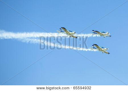 BERLIN, GERMANY - MAY 21, 2014: Aerobatic team 3x Fly Sinthesis Texan Top Class (Wefly team, Italy) performance during the International aviation and space exhibition ILA-2014.