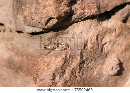 Two Wedding Rings On A Stone Wall