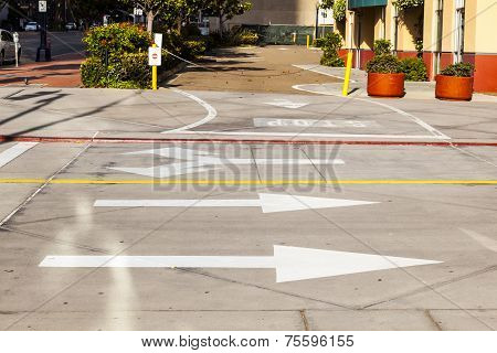 Arrows And Lines On The Asphalt To Indicate The Direction Of Driving