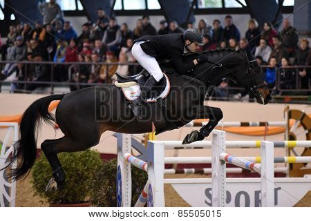 KAPOSVAR, HUNGARY - MARCH 15: Balazs Varga jumps with his horse (JLO) on the Masters Tournament International Jumping Competition, March 15, 2015 in Kaposvar, Hungary