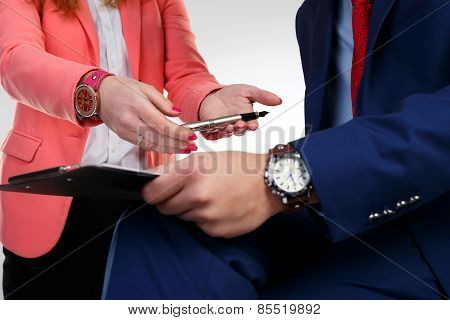 Secretary in a pink jacket takes a pen boss.