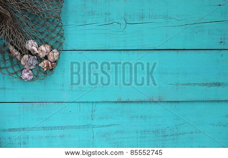 Blank wood beach sign with shells in fish net