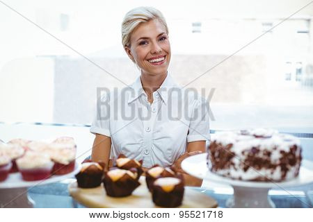 Selfassured female waitress in the bakery