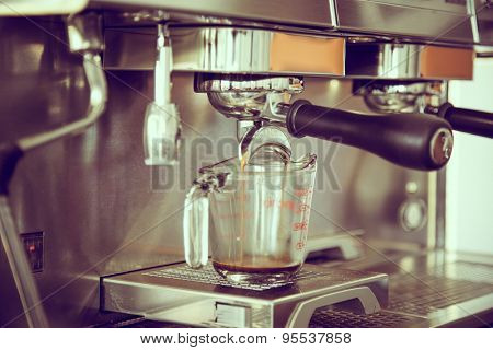 Prepares espresso in coffee shop ( Filtered image processed vintage effect. )