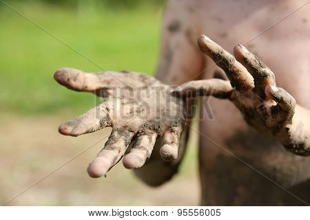 Close Up On Muddy Hands Of Little Boy