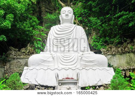 Majestic View Of White Buddha Statue Among Foliage Of Trees
