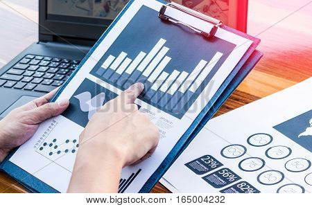 Business Workers Discussing Digital Graphs And Diagrams Indicating Progres.