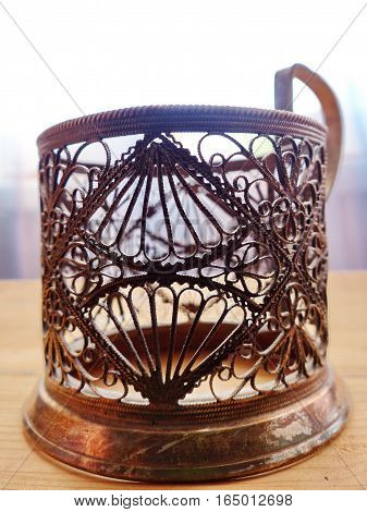 Cup holder. He appeared on the Russian railway in 1892. Cupronickel, tracery pattern. Closeup. Retro.