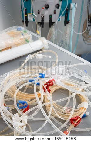 Blood tubes with hemodialysis machine in the background. Health care blood purification kidney failure transplantation medical equipment concept.