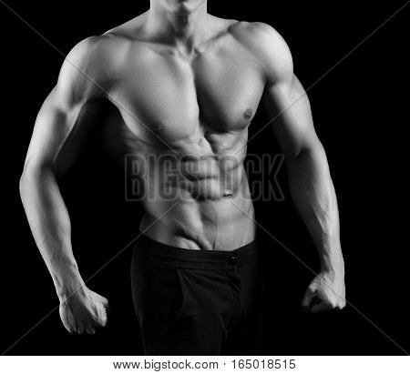 Every inch is perfect. Cropped monochrome shot of a fit and toned man posing shirtless