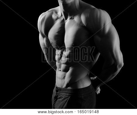 Athlete soul. Black and white cropped shot of a male bodybuilder showing off his muscles