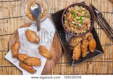Chef decorated fried chicken wings served with fry rice / cooking fried chicken wings concept