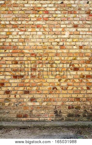 Yellow brick wall background with concrete basement