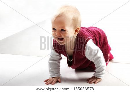 Shot of an adorable baby girl in red clothes playing with some wooden toys.