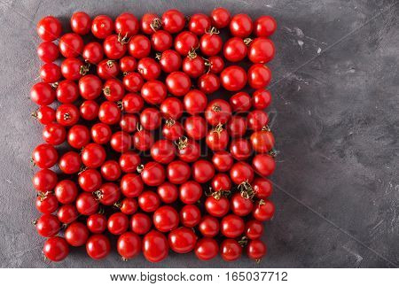 Cherry tomatoes in a square form. Colorful tomatoes Tomatoes background. Fresh tomatoes Healthy food concept. Colorful festive still life. Loosely laid tomatoes in different positions.