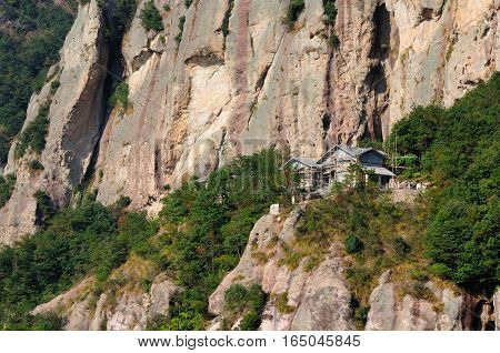 A building being built on the rocky cliffs in the Fangdong scenic area of Yandangshan located in Zhejiang province China.